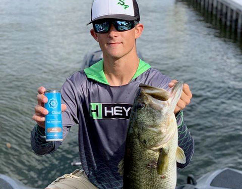 Jake Stine with large bass after bass fishing with BaitCloud Fish Attractant Balls.